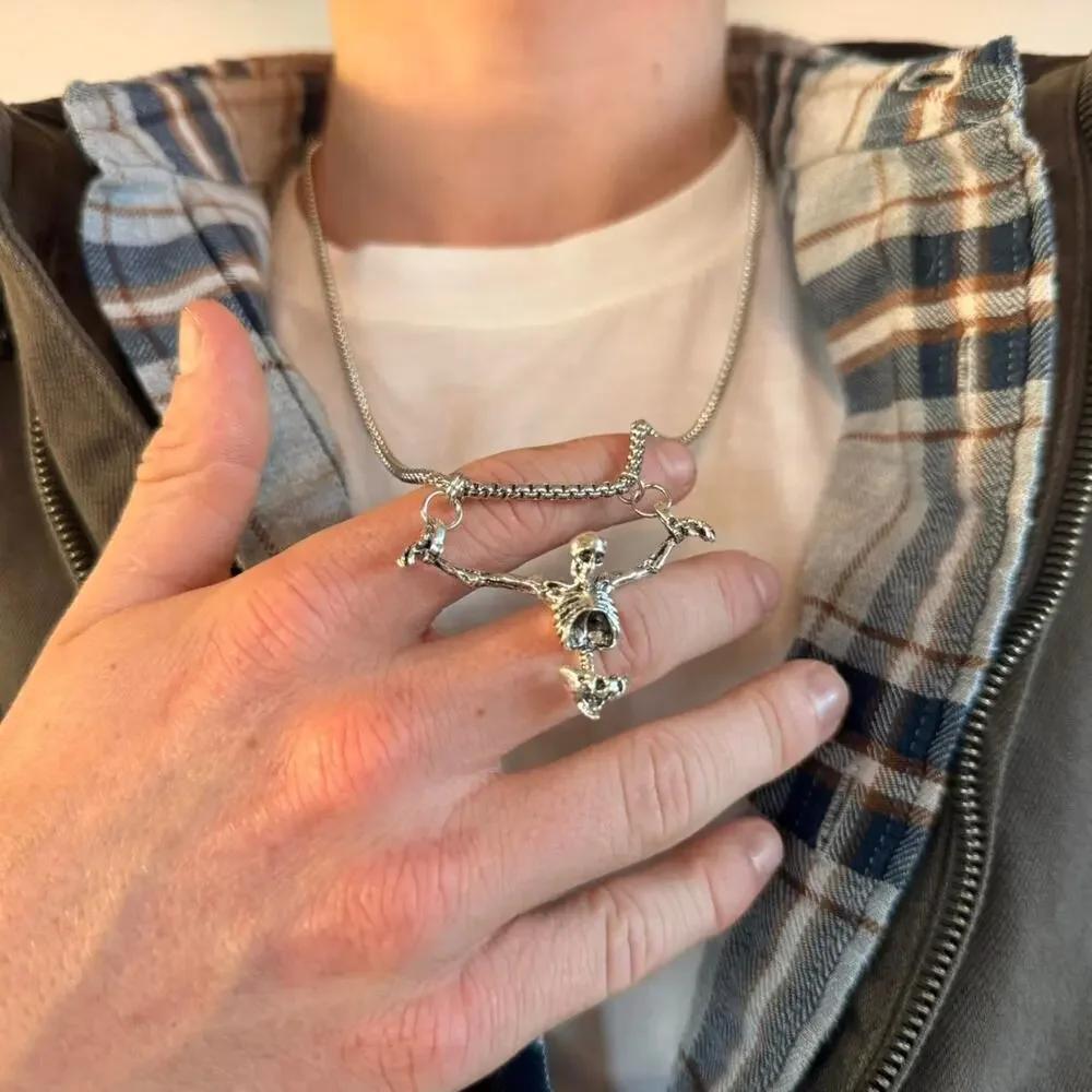 Unisex silver skeleton necklace featuring a bold, grunge-inspired design